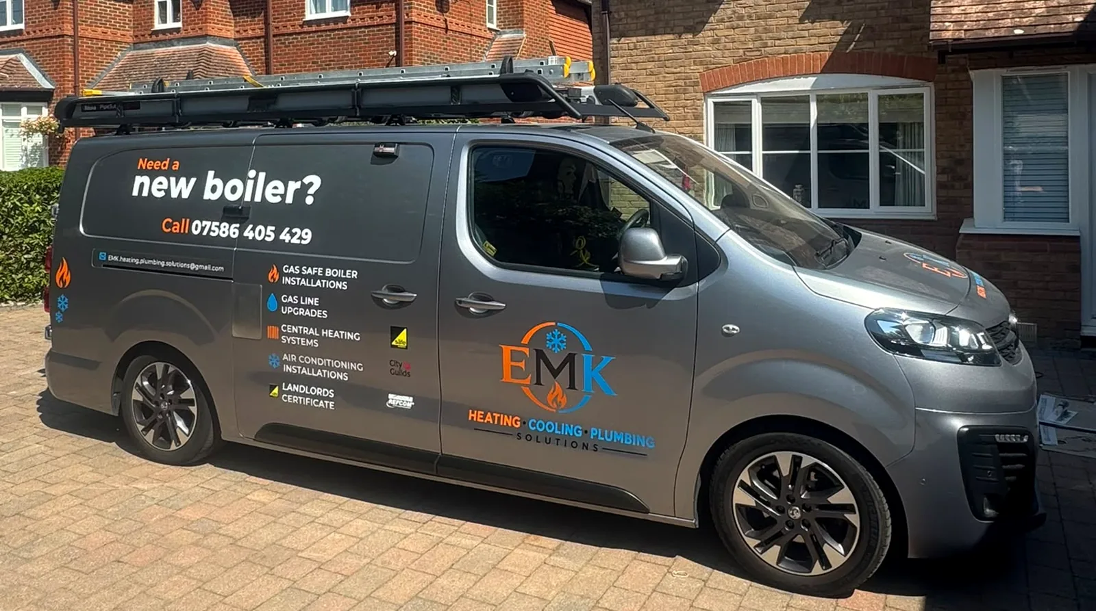 EMK's silver work van, Gas Safe registered, parked on a Leicester street
